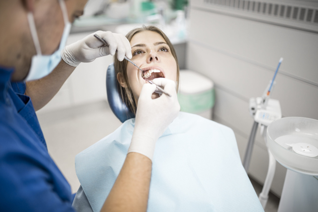 Young Woman Getting Dental Treatment In Clinic